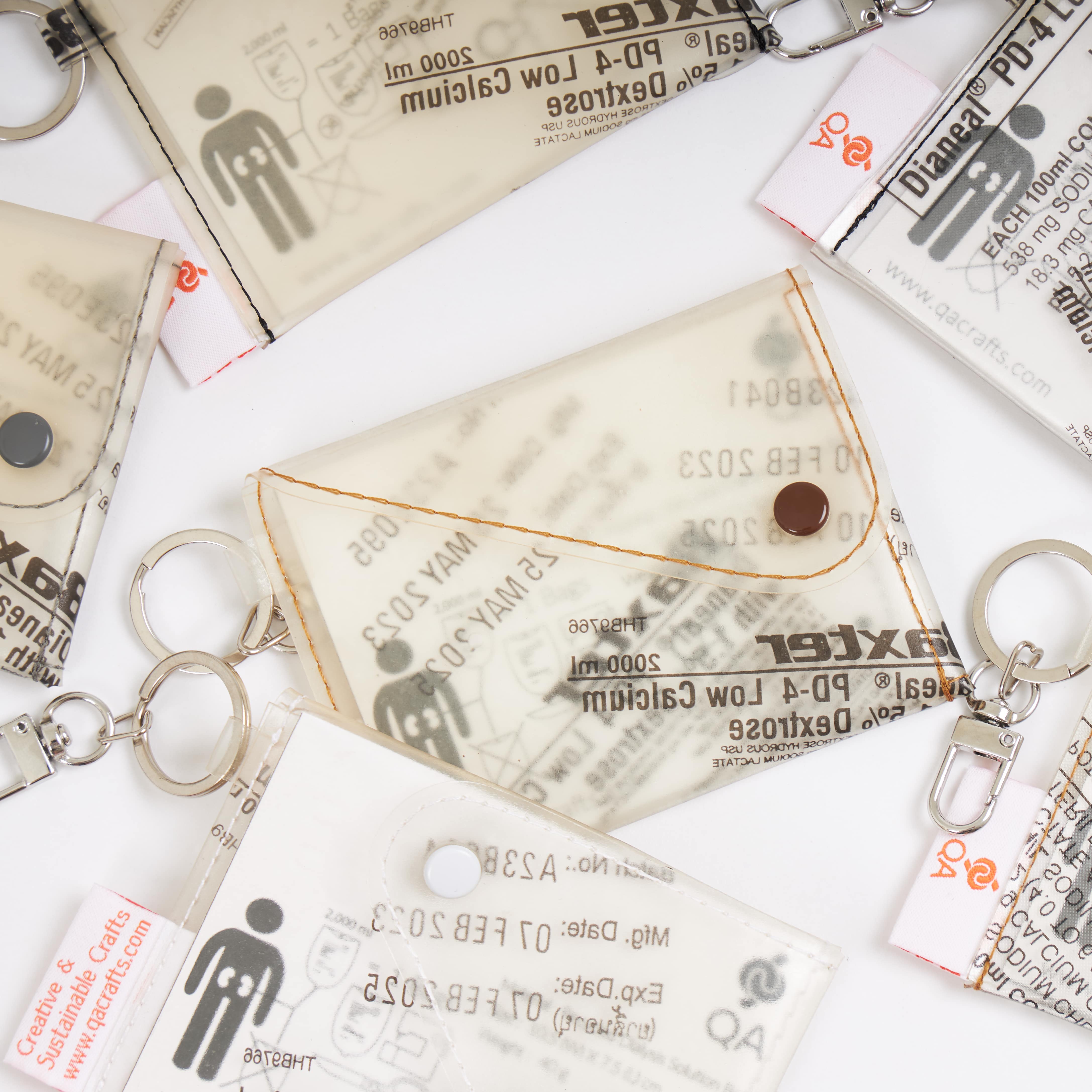 Handicraft sustainable and recycled wallet from Asia. The wallet is made of recycled dialysis bag and is sold online on www.qacrafts.com.